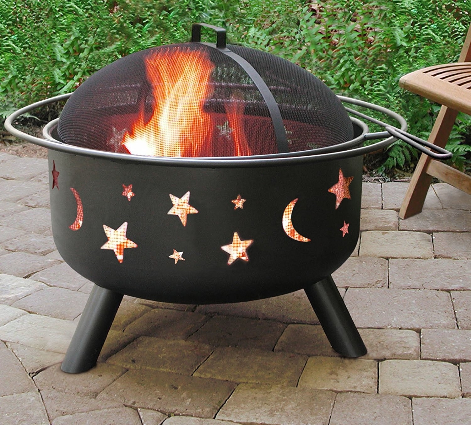 fire pit with cutouts of stars and moons on the side