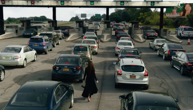 Debbie walks through traffic.