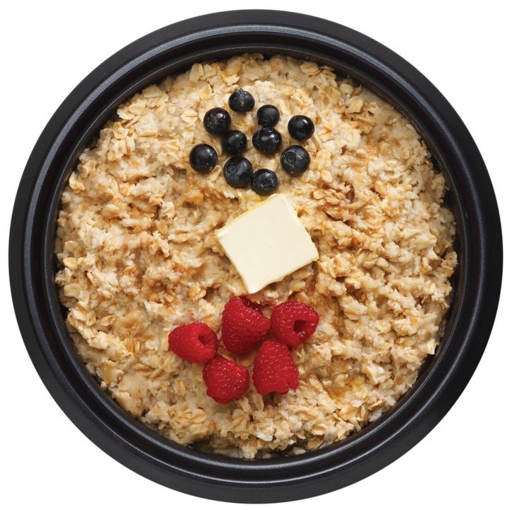 a oatmeal of rice with berries and butter on top