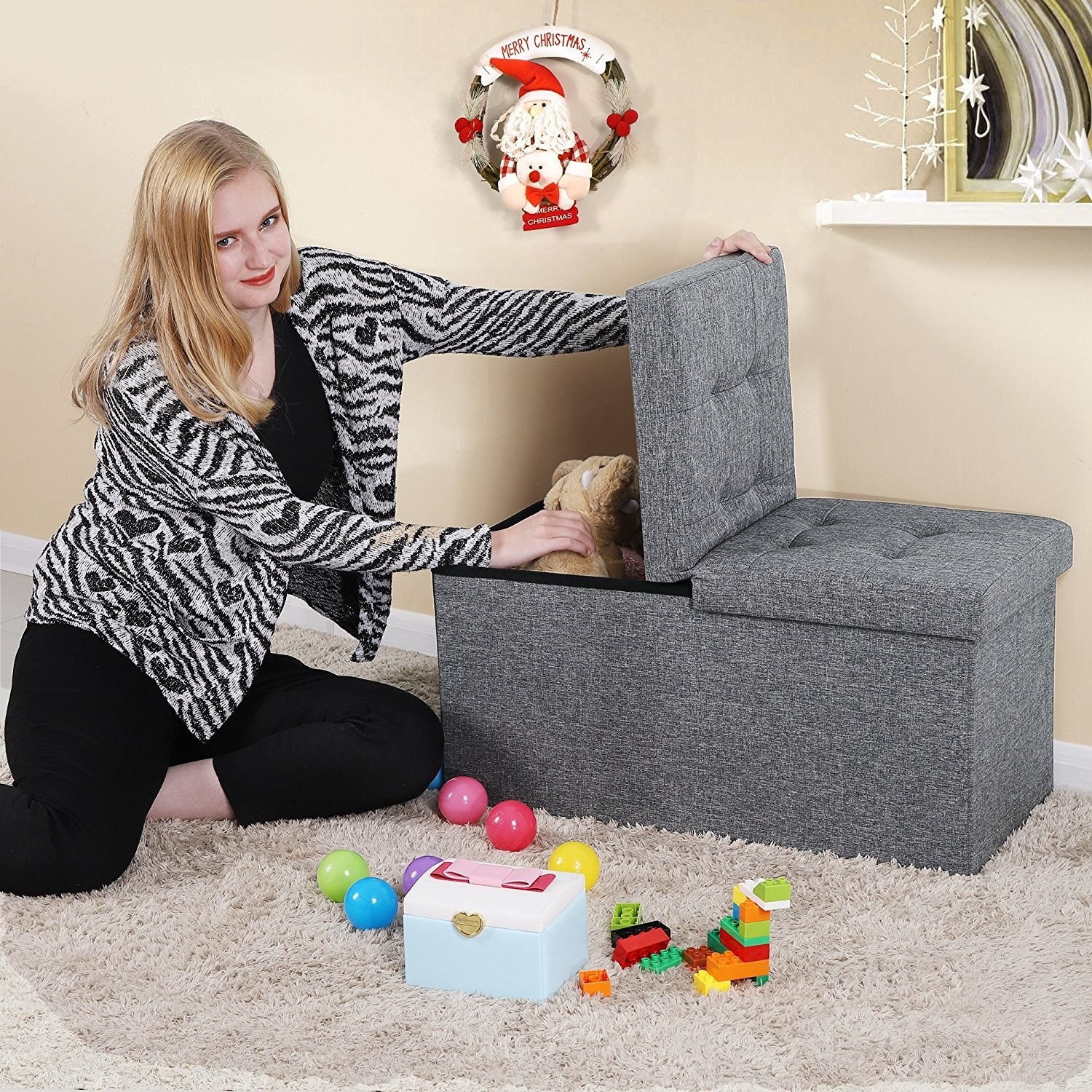 person putting toys into a storage ottoman