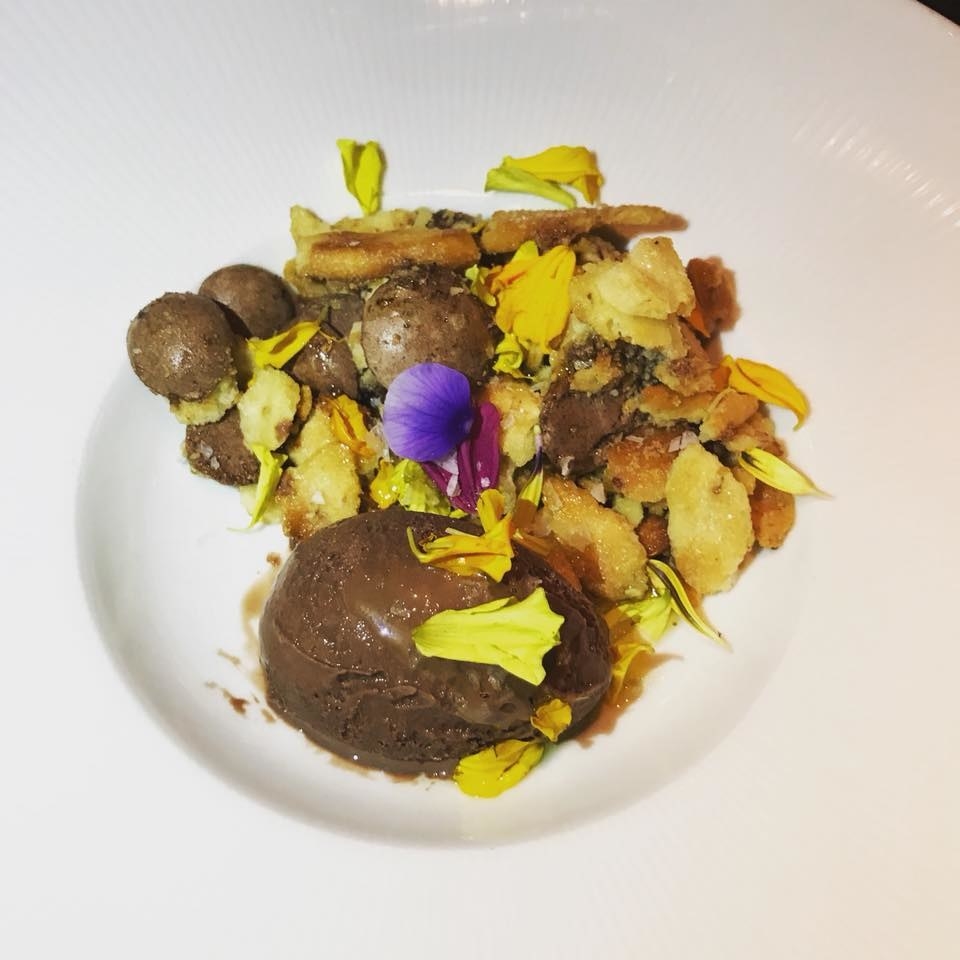 End the meal on a sweet note with this beautiful dessert made with a melange of Seville-style honey and olive oil cookie crumbs, crispy cocoa meringue, and Marcona praline with a drizzle of Gianduja tuffle. The scoop of rich chocolate ice cream with sea salt pairs well for this perfect bite.