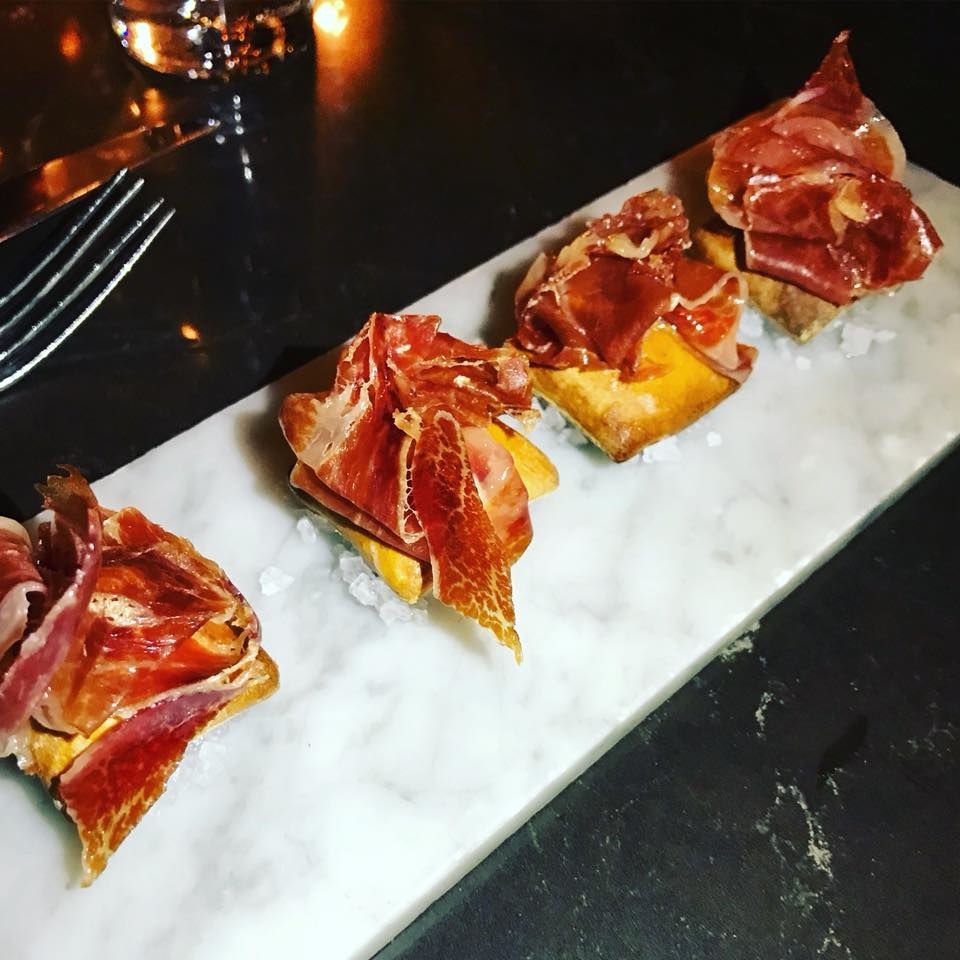 Inside crispy, puffy baguette are savory la Peral cheese (reminiscent of bleu cheese) and citrust quince paste, topped with thin slice of Iberico scales and then served atop balsamic salt.