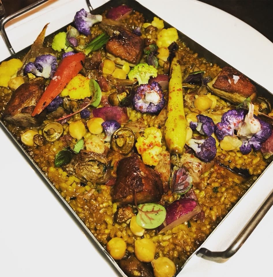 Served on a wide, flat pan, the "paella" features a bed of calasparra rice with crescent duck, cauliflower, garbanzos, black trumpet mushroom, and seasonal flowers to create this eye-pleasing dish that is equally as delicious.