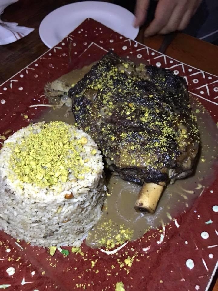This family-style entree features braised lamb shoulder stuffed with spiced rice & minced beef garnished with nuts. The fall-off-the bone meat is extremely tender, and is complemented by a side of spiced rice topped with nuts.