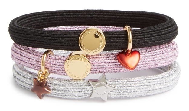 A set of three elastic Marc Jacobs hair bands detailed with fun tiny charms.