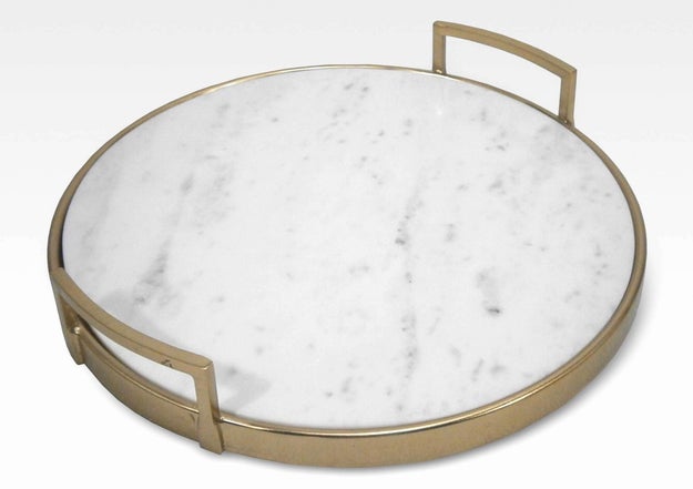 A marble and gold serving tray that could make water and potato chips look like a five-star meal.