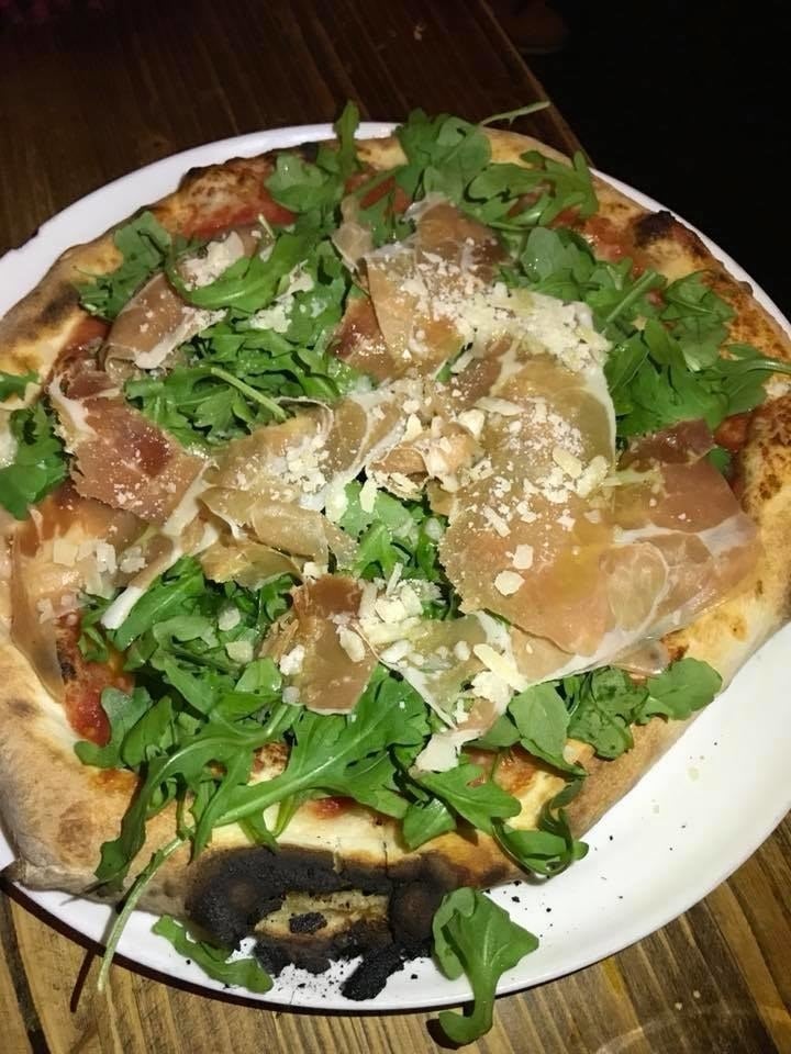 The thin crust pizza with chewy yet light dough smothered in San Marzano tomato sauce is topped with gooey mozzarella di bufala and a generous amount of arugula, aged prosciutto San Daniele, parmigiano reggiano, extra virgin olive oil, and basil.