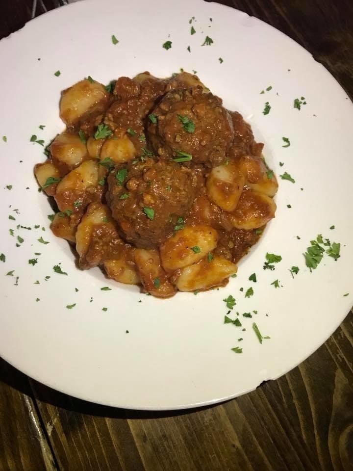 Chewy potato gnocchi can be prepared in your choice of four different sauces - Sorrentina, Quattro Formaggi, Pesto, or Bolognese (pictured above). The savory blend of organic veal, pork, beef, celery, carrots, spinach, and onions in rich tomato sauce complete the perfect gnocchi, and topped with two meatballs.