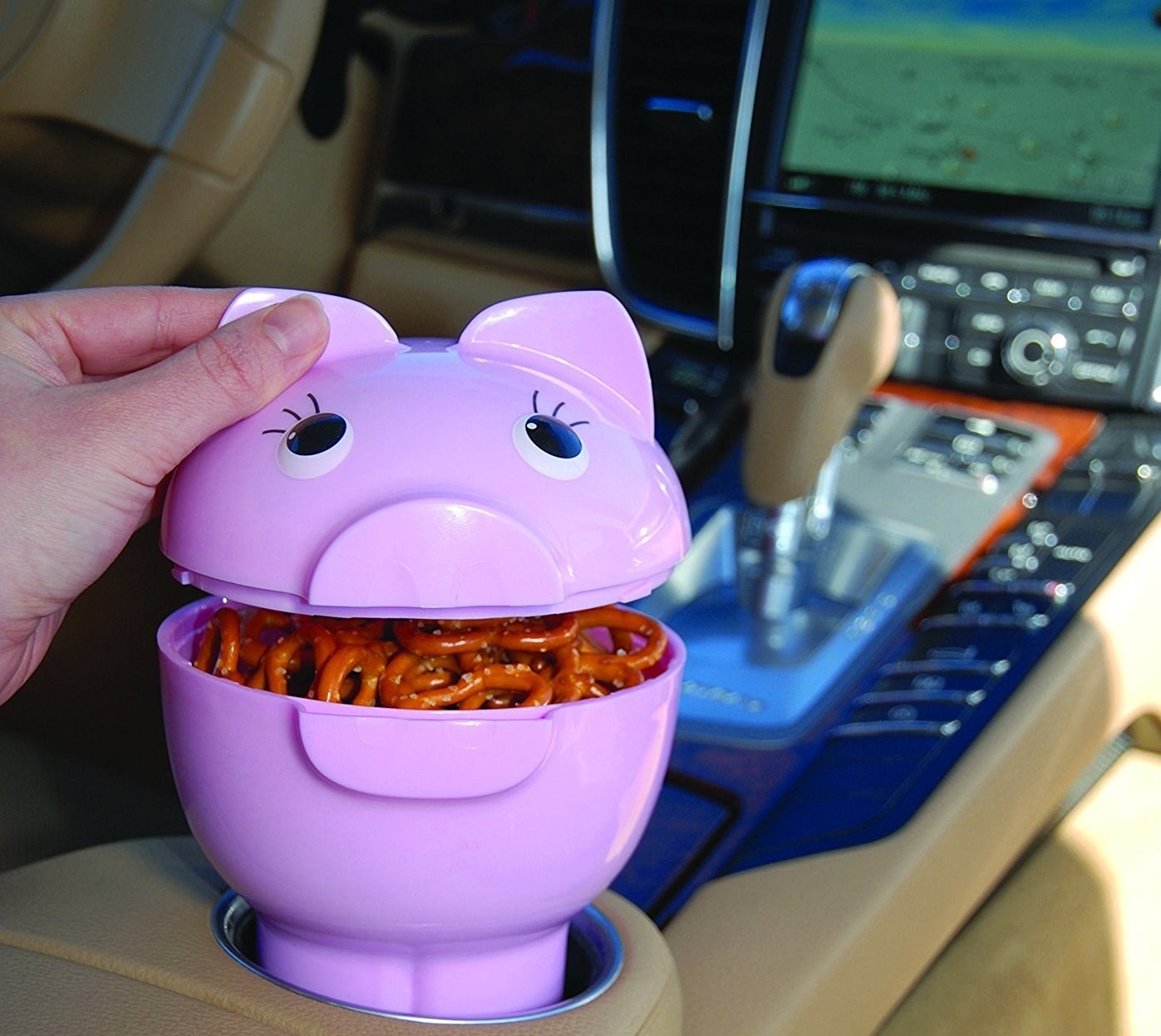 reviewer photo of pig container in car holding snack 
