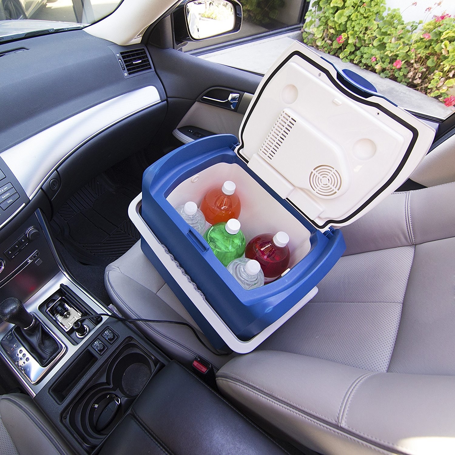 reviewer image of cooler holding drinks in front seat of car 
