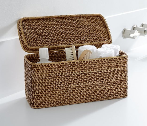 Place miscellaneous items (like extra TP, hand towels, or toiletries) in a lidded basket.