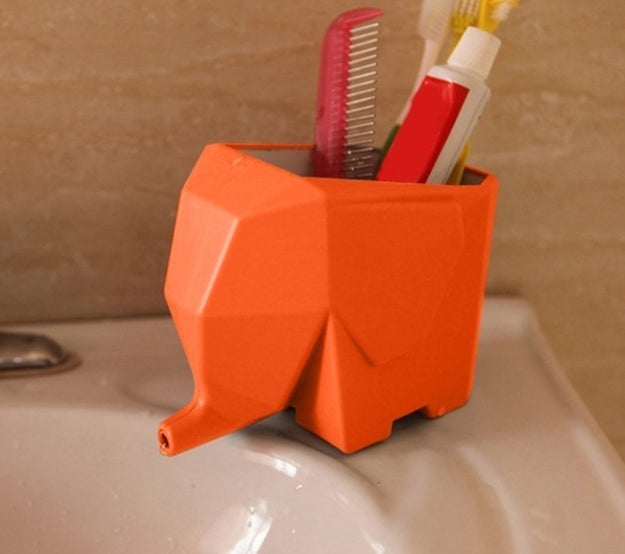 Keep your toothbrushes and toothpaste neat and dry in an adorable elephant holder that drains through the trunk.