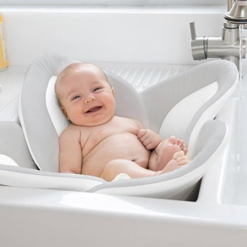 Baby inside sink sitting in padding