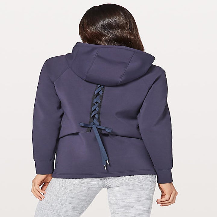 model wearing blue puffer jacket with tie back 