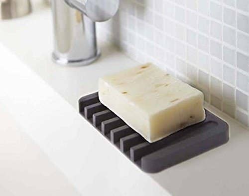 gray soap dish with slots for draining water into the sink 