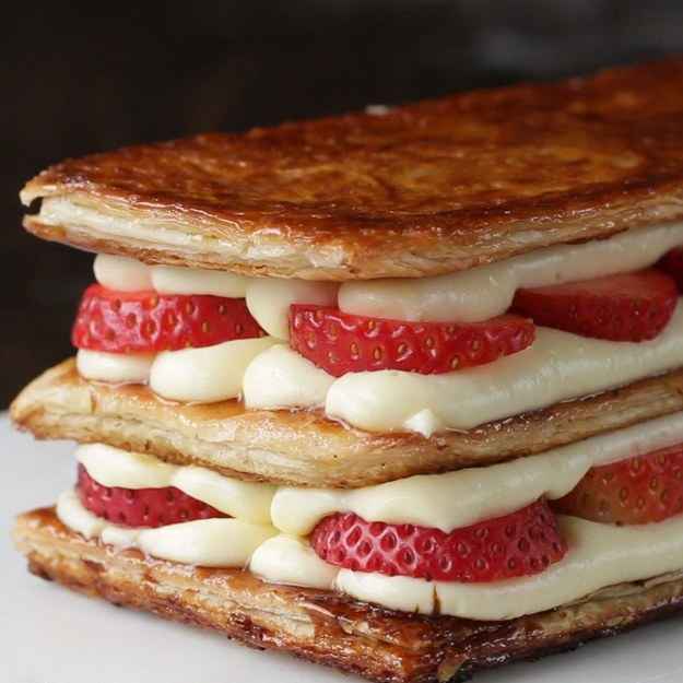 3 servingsINGREDIENTS1 puff pastry, thawed3 teaspoons sugarCustard2 egg yolk65 g (1/3 cup) sugar2 tablespoons cornstarch1 teaspoon vanilla extract240 mL (1 cup) milk6 strawberry, slicedPREPARATION1. In a microwave-safe bowl, whisk the yolks and sugar until pale in color.2. Add cornstarch and whisk well. Add the vanilla extract and milk. Whisk until well combined.3. Loosely cover the bowl with plastic wrap and microwave for 4 minutes, stirring halfway through. Remove plastic and stir.4. Cover with a plastic wrap and chill at least 30 minutes.5. Cut the thawed puff pastry into three equal-sized rectangles.6. Pierce each piece of puff pastry with a fork.7. Heat a nonstick pan over low heat. Place the puff pastry in the pan and cook for 10 minutes.8. Flip the puff pastry sheets, and place a lid on the top of the pan. Cook for 10 minutes.9. Remove the lid and sprinkle 1 teaspoon of sugar on sheet of puff pastry. Flip the pastry over so that the sugared side is on the bottom.10. Bring the heat up to high. Place a piece of parchment paper over the puff pastry and weigh it down with another pan. Once the surface is caramelized, about 1- 2 minutes, remove from the heat and let cool to room temperature on a cooling rack.11. Place the custard in a piping bag fitting with an large round tip.12. Pipe the custard on one sheet of puff pastry. Top with a layer of sliced strawberries, then pipe another row of custard. Top with another sheet of puff pastry, custard, sliced strawberries, custard, and the remaining puff pastry sheet.13. Dust the top with powdered sugar.14. Enjoy!