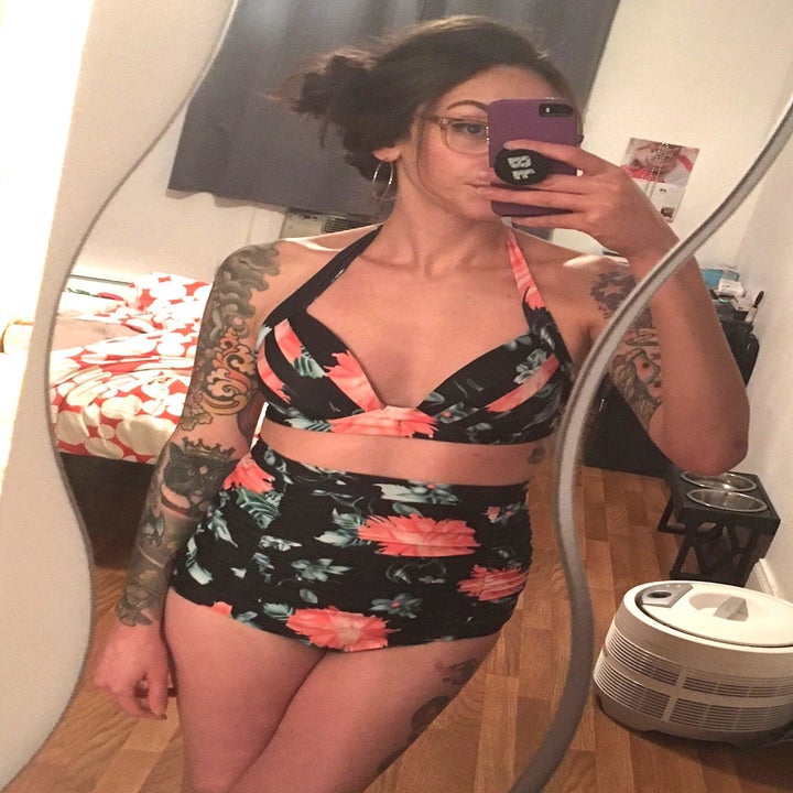 A person taking a mirror selfie in the floral bikini