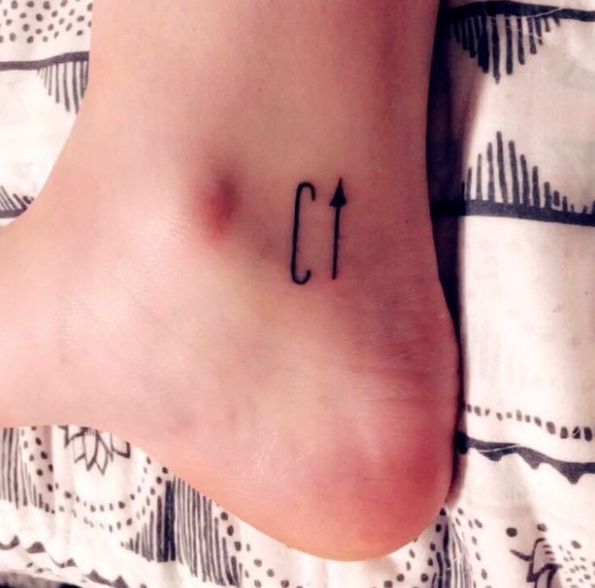 C with an arrow tattoo