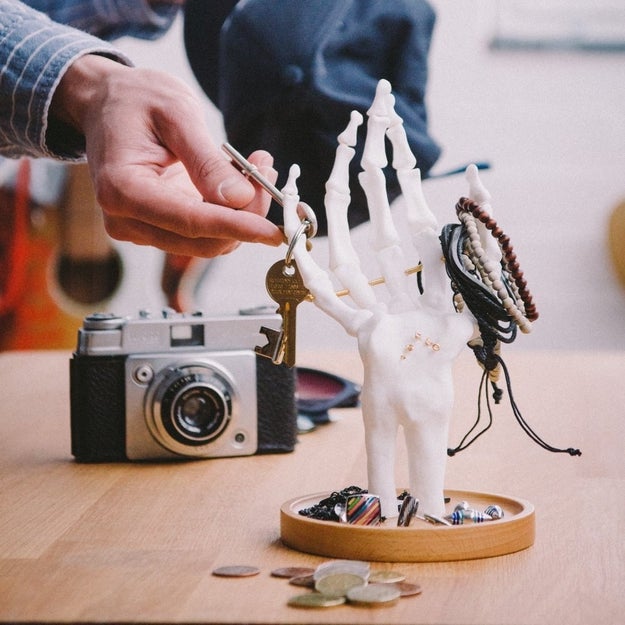 A skeleton hand reaching out from the grave — to hold your jewelry.