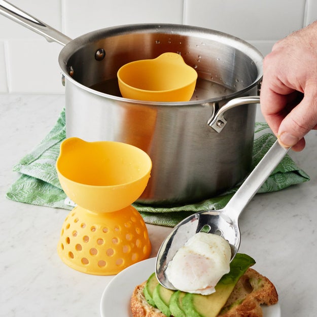 A set of silicone egg poachers with perforated cups to mimic the traditional poaching method (aka swirling water around and around) without having to do any work — and so your egg stays perfectly round and never wisps away.