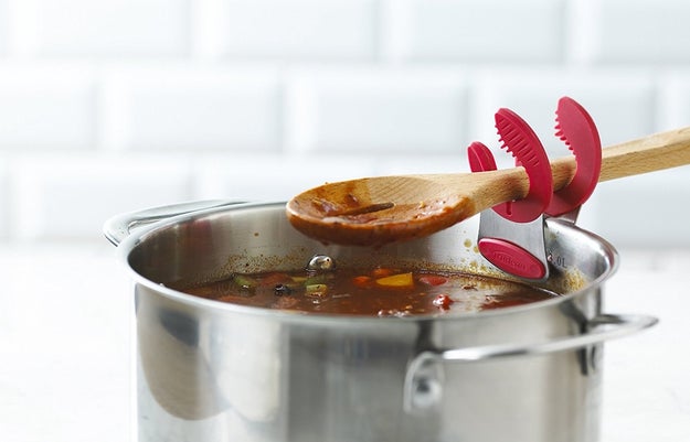 A clip-on spoon rest so all the good stuff drips back *into* your pot rather than onto your sparkling countertop — and so you don't get ~crabby~ having to scrub your surfaces down later.