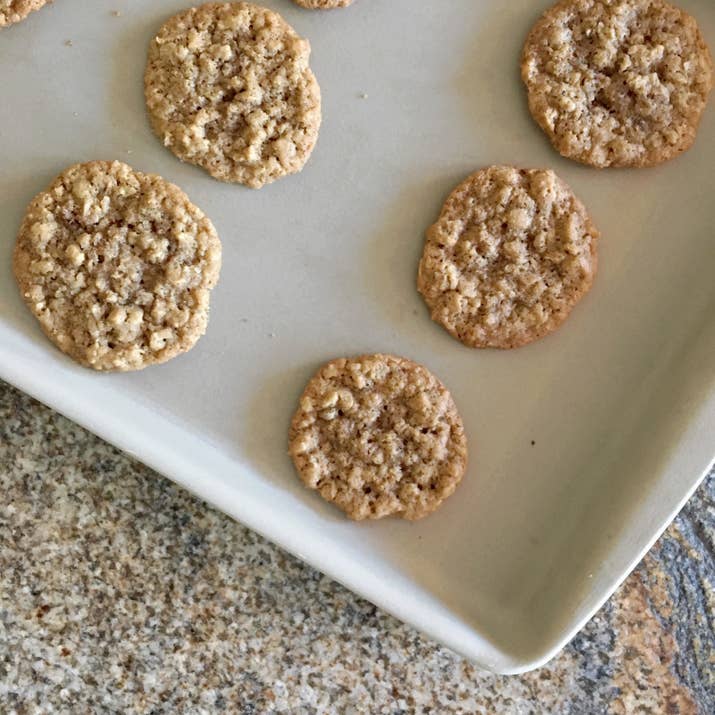 I've been using this baking pan for 11 or 12 years now — ever since I was a teen making batches of chocolate chip cookies — and I still don't like to bake cookies on anything else. I swear that cookies bake more evenly and consistently on it than any other pan, the cookie bottoms NEVER burn (unless you *really* over cook them, then yeah, burning might happen), and it's always easy to get the cookies off once they're done with their first short cool. It doesn't have a nonstick coating, but rather builds up ~seasoning~ as you cook over time, much like a cast-iron skillet. That seasoning lets you skip the layer of parchment paper, so you use less of that. Also like a cast-iron, you don't clean it with dish soap: It comes with a little plastic scraper, and you simply run the pan under hot water and scrape off all the excess crumbs. I even use it to roast chopped veggies, or make a veggies-and-chicken sheet pan dinner. One small warning: If you don't spread the food evenly over the sheet per the directions (i.e., try to do what I did and roast two halves of a big spaghetti squash right in the center of the pan) the temperature difference between the cooler part of the pan (under the squash) and the rest of the pan as it heats up in the oven will make the pan crack in half! But that wasn't a deal breaker for me, and I definitely got another one — I have other pans that'll happily roast my spaghetti squash, like the cast-iron skillet — but I need the bar pan for cookies! —Natalie BrownGet it from Pampered Chef for $37.