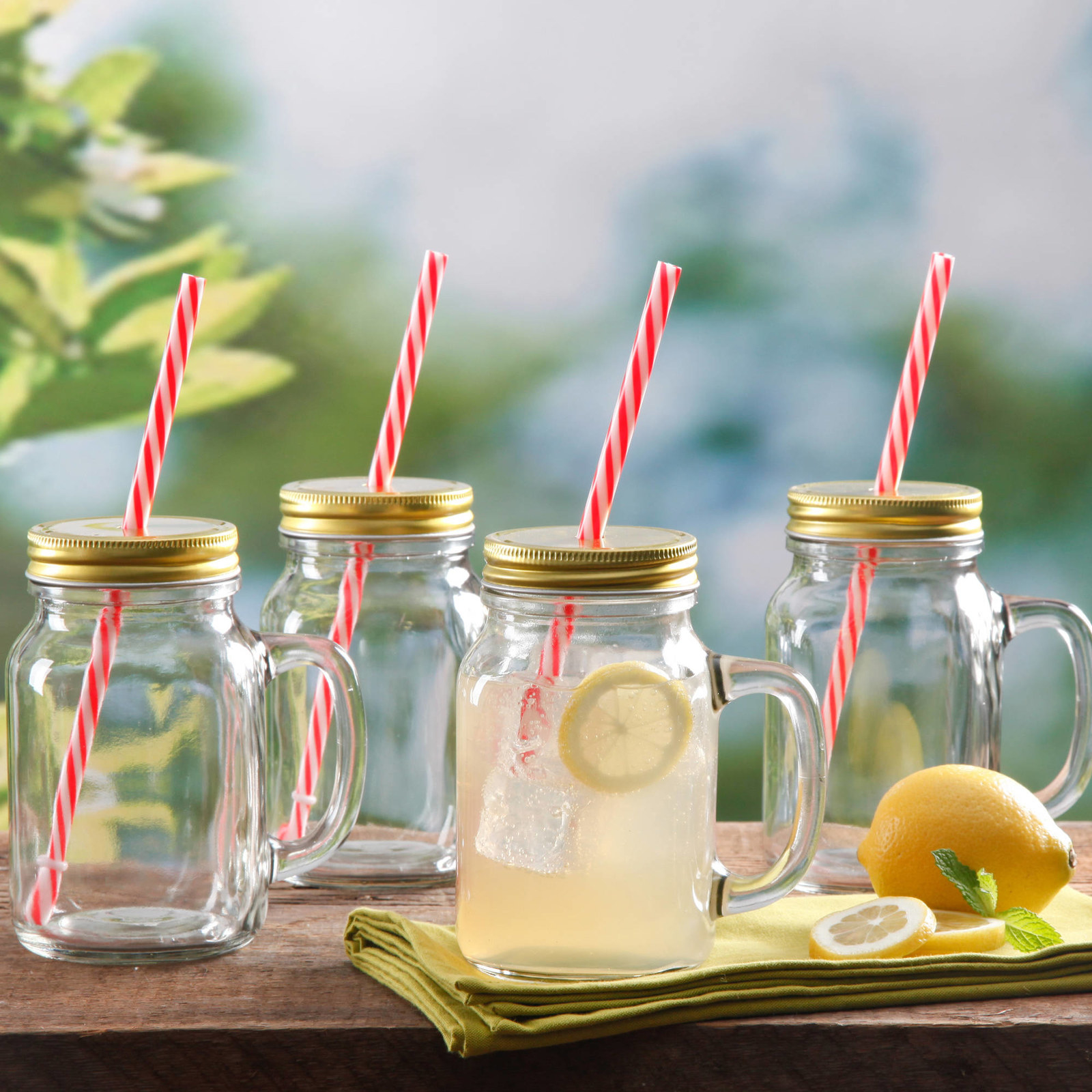 The mason jar drinking glasses with straws in them