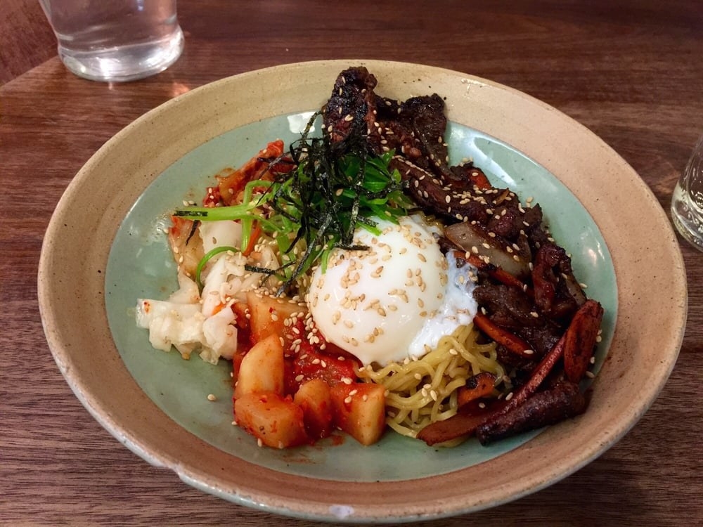 This saucy, brothless ramen highlights tender ribeye "bulgogi" marinated in soy sauce, and includes seasonal kimchi, scallions, and poached egg, and topped with a sprinkle of sesame seeds. You get a choice of rice or ramen noodle.