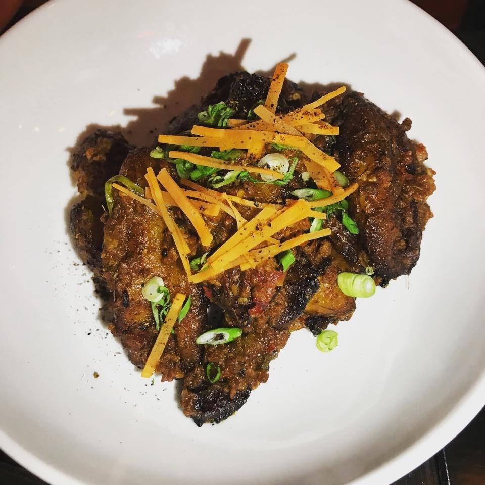 A fun twist on the Chinese favorite mapo tofu, the Mapo Maduros is instead made with sliced plantains tossed with spicy pork and Sichuan peppercorns, and topped with scallions and carrots.