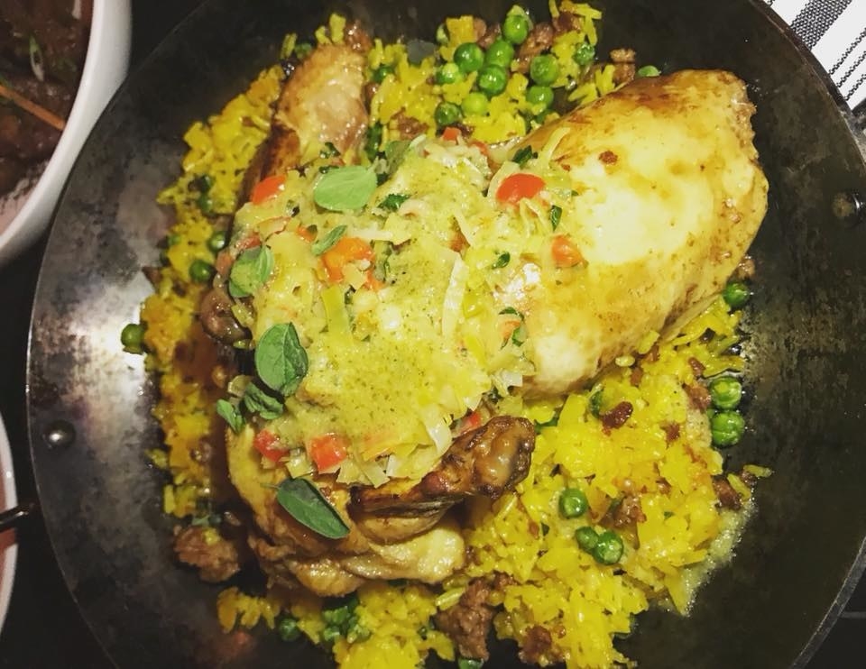 Similar to paella, the Chicken and Yellow Rice is a delectable dish of moist, juicy chicken thigh and breast served over fried yellow rice with chorizo, bell pepper, and peas. The hot pan leaves crispy texture to the rice.