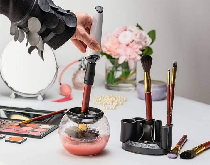 Includes a brush spinner, charging station, rubber collars, glass bowl, bowl splash guard ring, and a cleaning solution. To use, simply fill the bowl with warm water and cleaning solution, use an appropriately sized rubber adaptor to attach the brush to the spinner and spin on the lowest setting, then remove the brush from the water (but still keeping it in the bowl) and spin to dry.Promising review: "Absolutely love it. Cleaning and drying all of my brushes by hand normally takes me about 4–5 hours once they are all totally dried. With this it's an hour max! Just be sure not to push your brushes all the way to the bottom or you will misshape them." —Justice A.Get them from Amazon for $49.99 or Jet for $49.85.