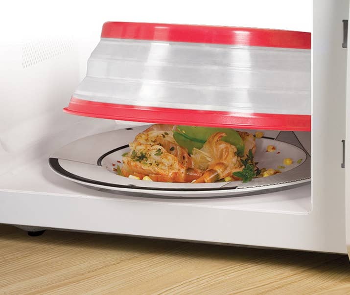 Has holes for steam venting. Size of 10.5" size fits most plates, expands to 3.5", and collapses to 1" for easy storage. Can be used expanded or flat on bowls. Heat-resistant up to 600 degrees F, BPA-free, and dishwasher-safe.Promising review: "Really great product. It cleans easily, stores in a very small space, and helps protect the microwave from splatters and messes. I have seen no issues with it fitting over the food (bowls, plates, whatever) or losing shape or melting in any way. It is durable and saves me a lot of time cleaning out a disgusting microwave." —DoodleGet it from Amazon for $7.99 or a similar one from Jet for $6.75.