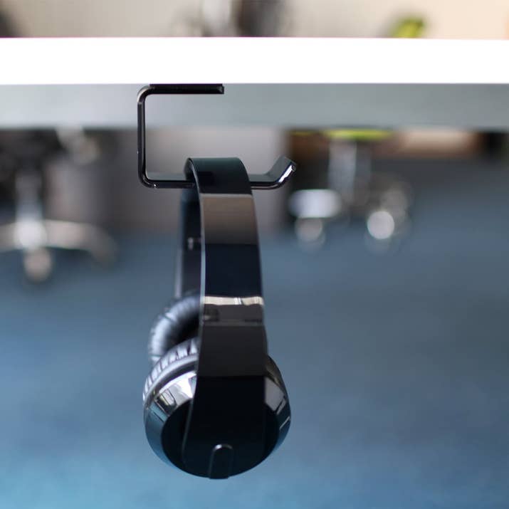 Adheres to a clean and smooth surface with double-sided adhesive.Promising review: "I wish I had bought a second one as I didn't realize how much this would come in handy! It helps to save space and offers a safe and out of the way resting place for your headphones so that they are not knocked off the desk, run over by your computer chair, stepped on, etc." —RebekahGet it from Amazon for $5.99.