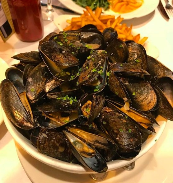 A classic French dish of steamed mussels in rich, white wine and butter broth, the Moules Mariniere is served with a side of pommes frites that are perfect for dipping in the hearty broth.