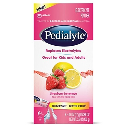 This shows a pink box of Pedialyte packets with a graphic of two lemons and three strawberries.