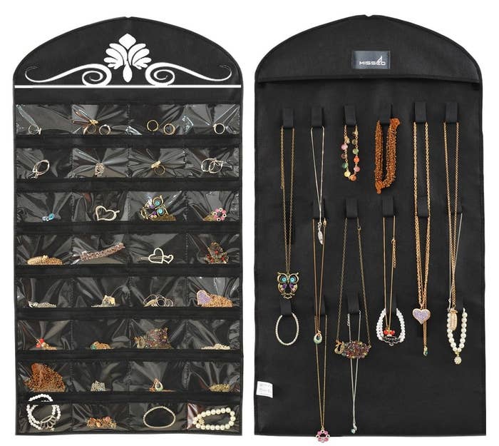An organizer that resembles a hanging clothing bag but has slots for necklaces on one side and plastic pockets on the other