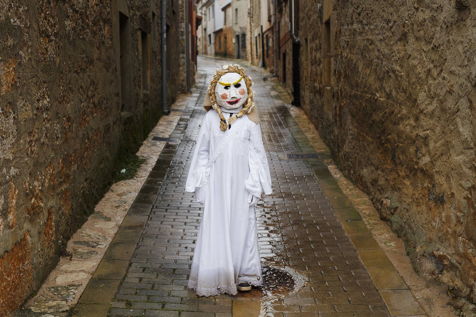 A reveler dressed as a child poses for pictures during El Gallo de Carnaval, or the Rooster Carnival, on Feb. 11 in Mecerreyes, Spain. During the Carnavaladas y Zarramacadas, people take to the streets in costumes made with ropes, bones, skins, scraps of cloth, oak leaves, and other rural items.