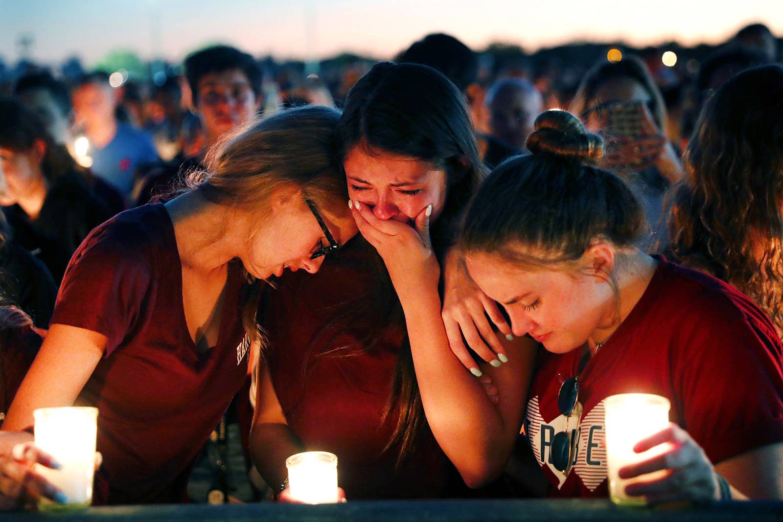Students console each other during a candlelight vigil on Feb. 15 for the victims of the shooting at Marjory Stoneman Douglas High School.