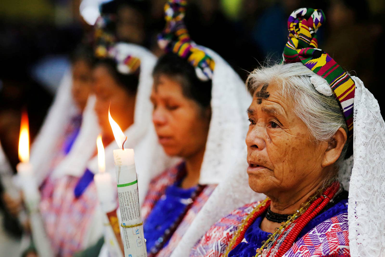 Indigenous Mayan women, with a cross of ashes on their foreheads, attend an Ash Wednesday mass in the municipality of San Juan Sacatepéquez, Guatemala, on Feb. 14.