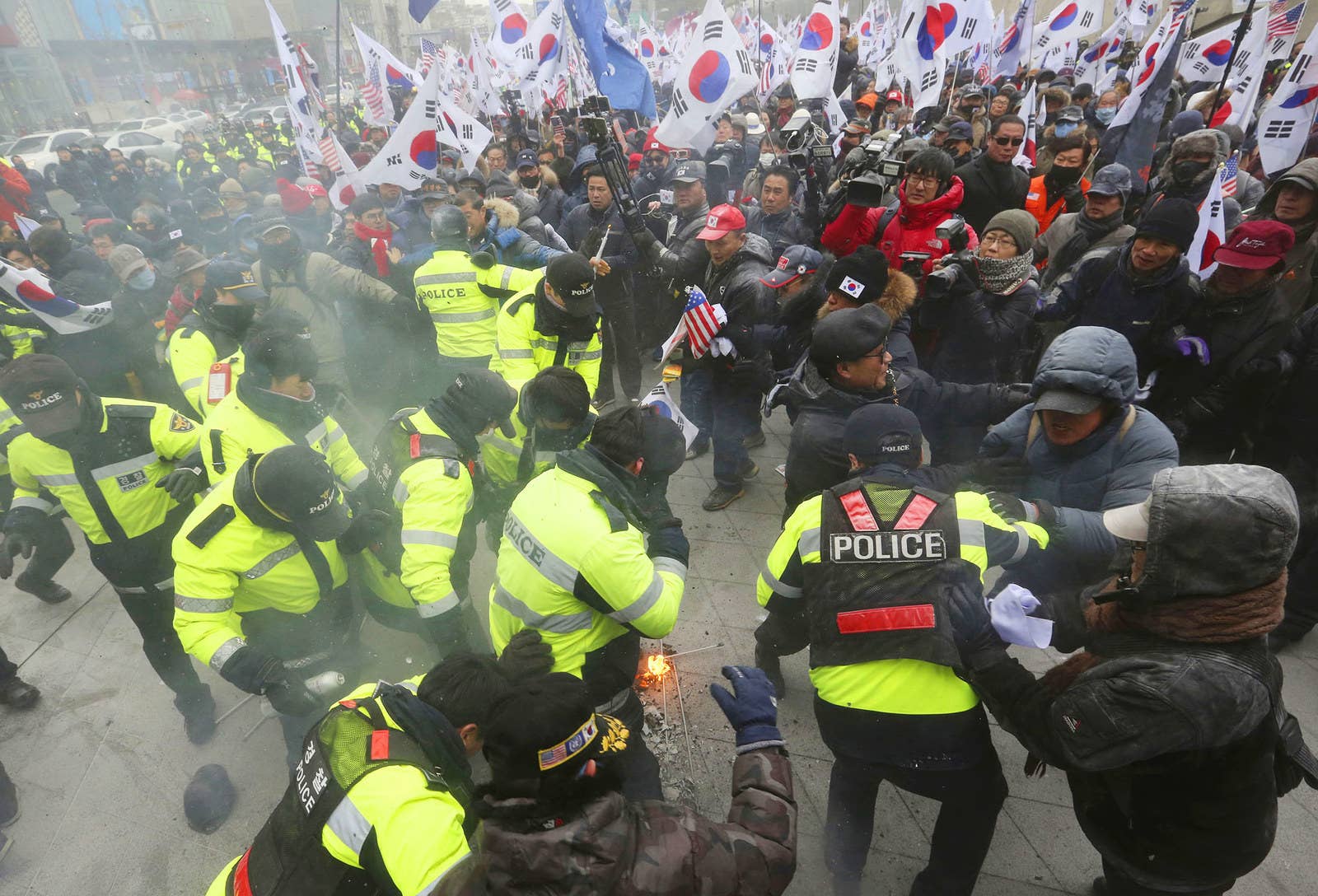 Protesters scuffle with police officers during a rally protesting North Korea's participation in the Pyeongchang 2018 Winter Olympics, in Seoul on Feb. 11.