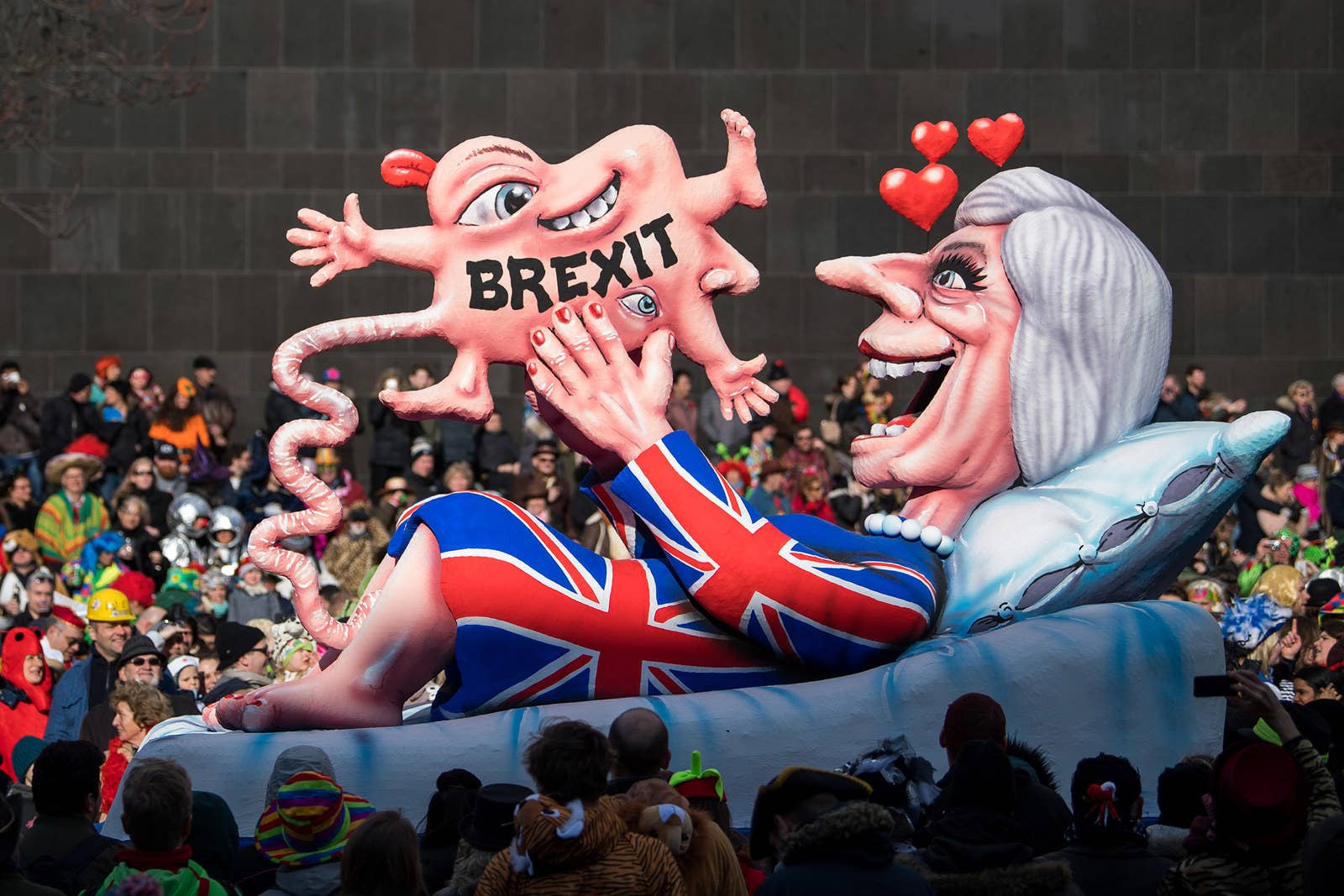 A float mocking Prime Minister Theresa May rolls past spectators during the annual Rose Monday parade on Feb. 12, in Dusseldorf, Germany. Political satire is a traditional cornerstone of the annual parades.