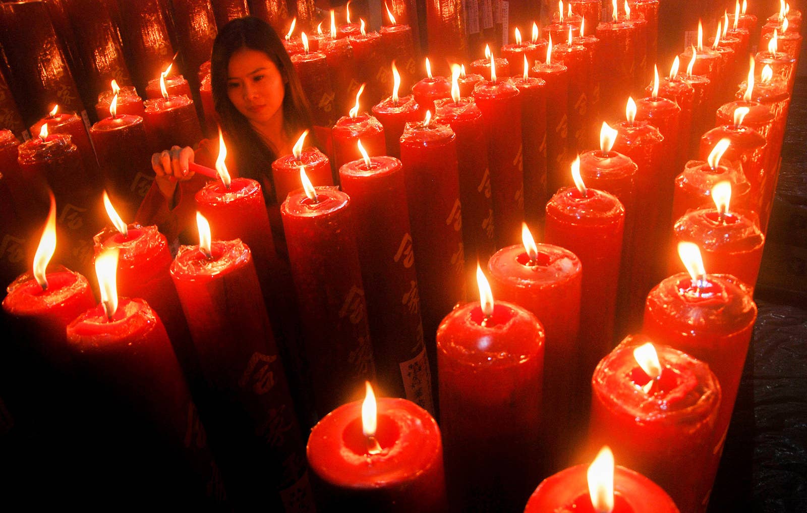 A woman lights a candle at a Chinese temple to mark the Lunar New Year in Bandung, West Java province, on Feb. 16.