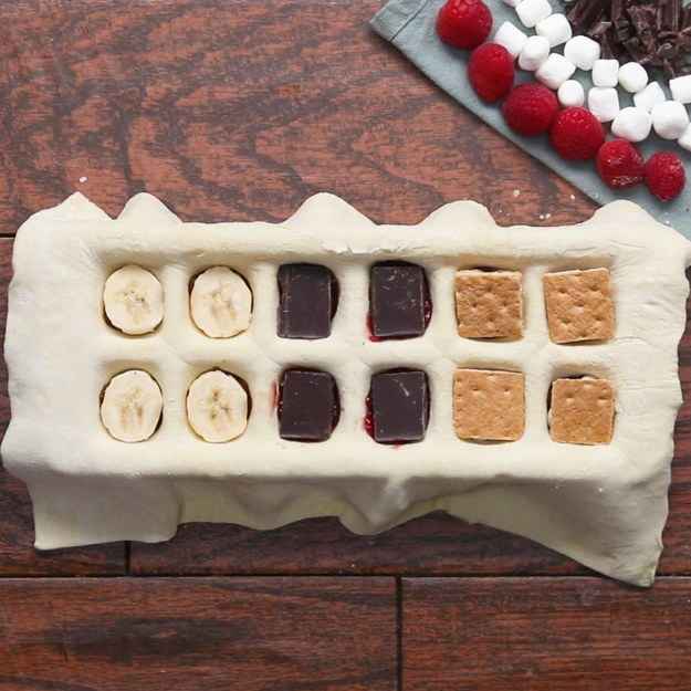 Savory Puff Pastry Pockets12 servingsINGREDIENTS250 g (1 cup) ricotta cheese20 g (½ cup) fresh spinach, cooked85 g (½ cup) artichoke heart, cooked and chopped½ teaspoon salt½ teaspoon pepper1 package frozen puff pastry, thawed25 g (¼ cup) shredded mozzarella cheese8 pepperoni, chopped3 tablespoons marinara sauce25 g (¼ cup) roasted red pepper, chopped2 tablespoons pesto1 mozzarella pearl2 tablespoons butter, meltedPREPARATION1. Preheat oven to 400ËF (200ËC).2. In a medium-sized mixing bowl, combine the ricotta, spinach, artichokes, salt, and pepper, and mix until fully incorporated.3. Lay a sheet of puff pastry dough over the ice cube tray and carefully press into the dough forming it to the ice tray.4. Place the shredded mozzarella, pepperonis, and marinara in the first four cube divots.5. Place the roasted red peppers, pesto, and mozzarella pearls in the middle four cube divots.6. Spoon the ricotta mixture into the last 4 cube divots.7. Place the other sheet of puff pastry over the ice cube tray and use a rolling pin to seal it. Chill for at least 10 minutes.8. On a parchment paper-lined baking sheet, invert the ice cube tray releasing the puff pastry pockets.9. Using a knife, cut any excess dough from the sides.10. Using a fork, press into the the edges of the pastry and seal.11. Brush the pastry with butter and bake for 30 minutes.12. Enjoy!---Sweet Puff Pastry Pockets12 servingsINGREDIENTS1 package frozen puff pastry, thawed55 g (¼ cup) chocolate hazelnut spread½ banana, sliced80 g (¼ cup) raspberry jam½ chocolate bar, broken into 4 squares45 g (¼ cup) chocolate chip12 mini marshmallow½ graham cracker, broken into 4 squares egg washPREPARATION1. Preheat oven to 400ËF (200ËC).2. Lay a sheet of puff pastry dough over the ice cube tray and carefully press into the dough forming it to the ice tray.3. Place a spoonful of chocolate hazelnut spread and a slice of banana in the first four cube divots.4. Place a spoonful of raspberry jam and a piece of chocolate in the middle four cube divots.5. Place the chocolate chips, marshmallows, and graham cracker into the last 4 cube divots.6. Place the other sheet of puff pastry over the ice cube tray and use a rolling pin to seal it. Chill for at least 10 minutes.7. On a parchment paper-lined baking sheet, invert the ice cube tray releasing the puff pastry pockets.8. Using a knife cut any excess dough from the sides.9. Using a fork, press into the the edges of the pastry and seal.10. Brush the pastry with egg wash and bake for 30 minutes.11. Enjoy!Inspired by:https://www.facebook.com/ciaopeoplecookist/videos/238395449971860/?permPage=1