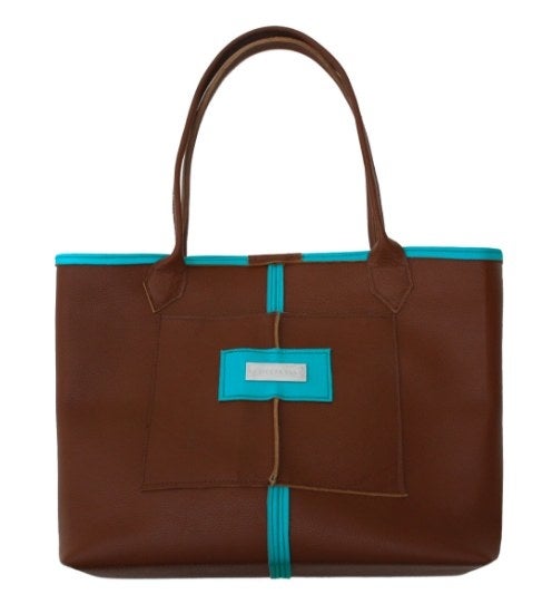 Handbag designer Kent Stetson specializes in handmade, one-of-a-kind collectible statement pieces. This practical everyday tote features two-toned luxurious leather. Sophisticated and fun for the office or play, the bag is designed unlined with a clasp closure, exterior pocket, and two key hooks.