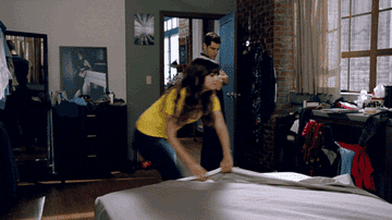 gif of person trying to pull sheets on the bed just to have one corner pop off
