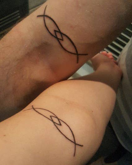 "My husband and I had been discussing our tattoo ideas for a while. I'm glad that a wine buzz inspired this design. It has multiple meanings. 1) Jesus fish since we are Jesus people, 2) interlocking to symbolise we are together in everything, and 3) we met on Plenty of Fish, the dating site. I love that these are on the opposite arm and visible when we hold hands." — lyonsemma16