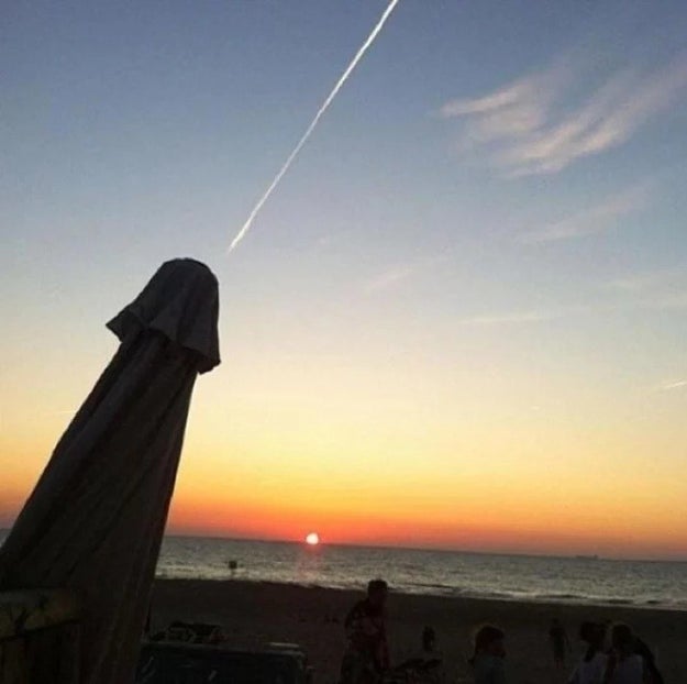 Technically, this is just a beach umbrella and the contrail of a passing jet, not an ejaculating penis.