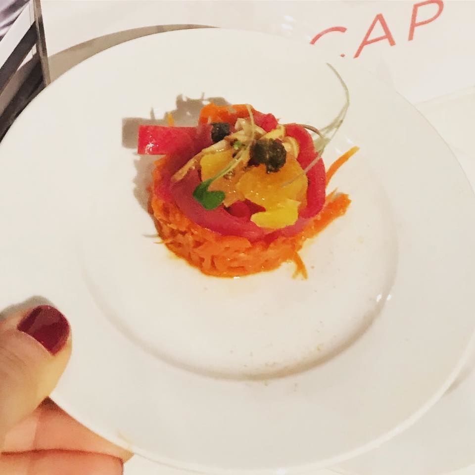 Carrot tartare topped with braised daikon in orange with cilantro and lime
