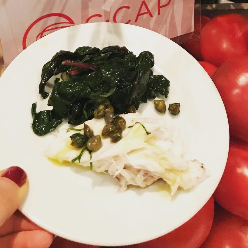 Whole lavraki (sea bass) is baked in sea salt and served with steamed greens