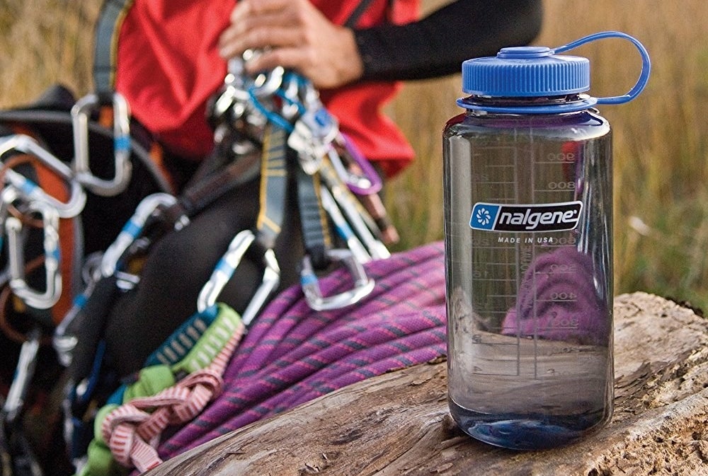 This water bottle is made of BPA-free plastics and metals. The wide-mouth opening means you can easily pour all of your liquids inside along with ice cubes, water purifiers, and filters! The top is attached via a loop-top that won't easily screw off or get lost. Plus, there's printed graduations on the side so you can keep track of how much you're consuming. Promising review: "I love this water bottle, one of the best purchases ever. It is very sturdy and holds up to anything, even the little hook on the lid is very heavy duty. The wide mouth is perfect for filling it with ice and not having to jam it in piece by piece. The wide mouth is also very helpful when hand-washing, because you can get a sponge or brush inside very easily. Overall awesome bottle, highly recommend." —Morgan RobertsPrice: $9.95+ (available in a variety of colors)
